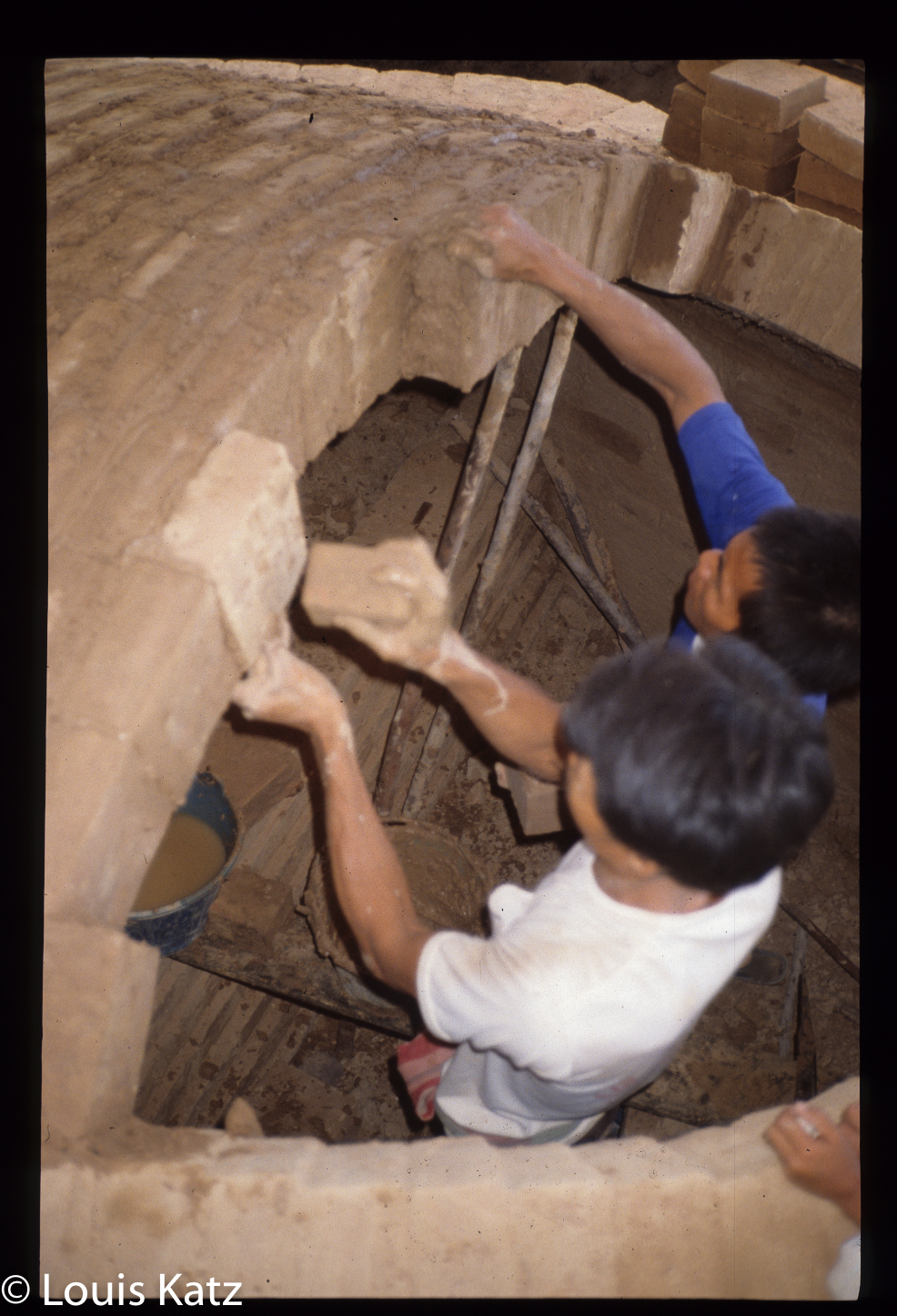 While the mortar is damp some bricks are tapped more firmly.