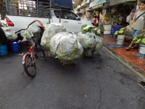Ten bundles of ten flowers wrapped in lotus leaves and plastic.