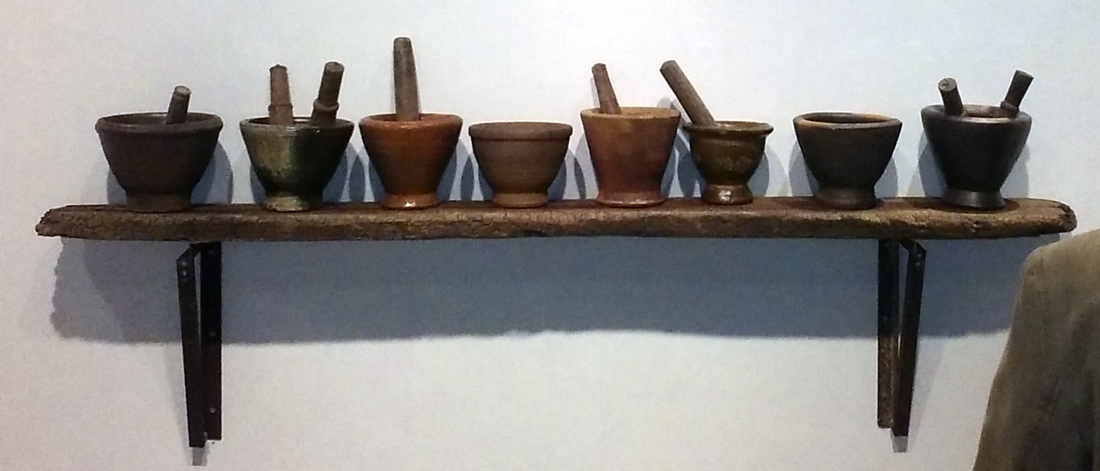 8 mortars on a shelf
