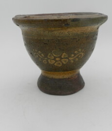 Profile image of mortar with flower decoration in white slip under a honey green colored glaze